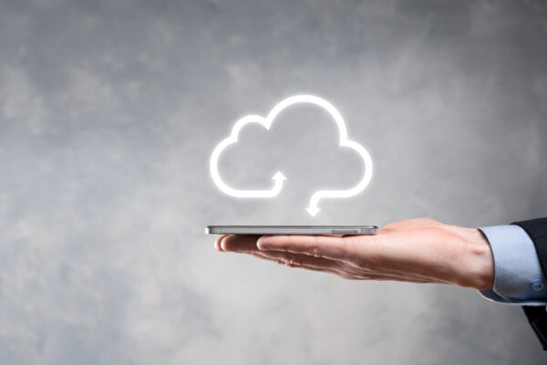 Man Holding Smartphone in Hand With Cloud Computing Logo Over It