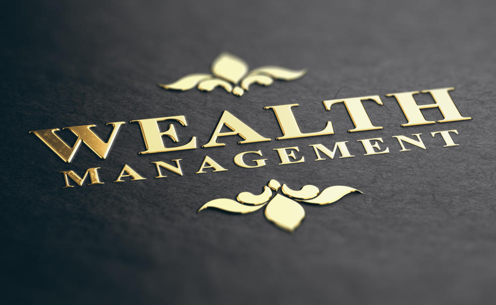 Wealth Management words in gold lettering on black background