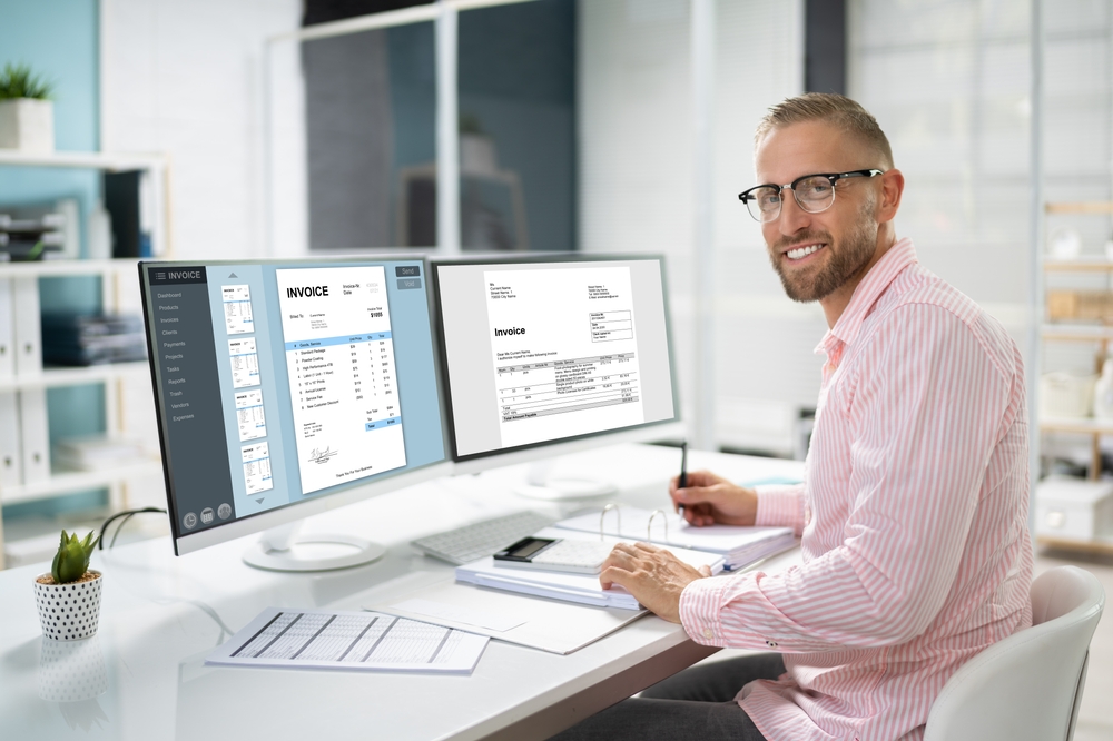 Businessman Finalizing Taxes on a Desktop Computer